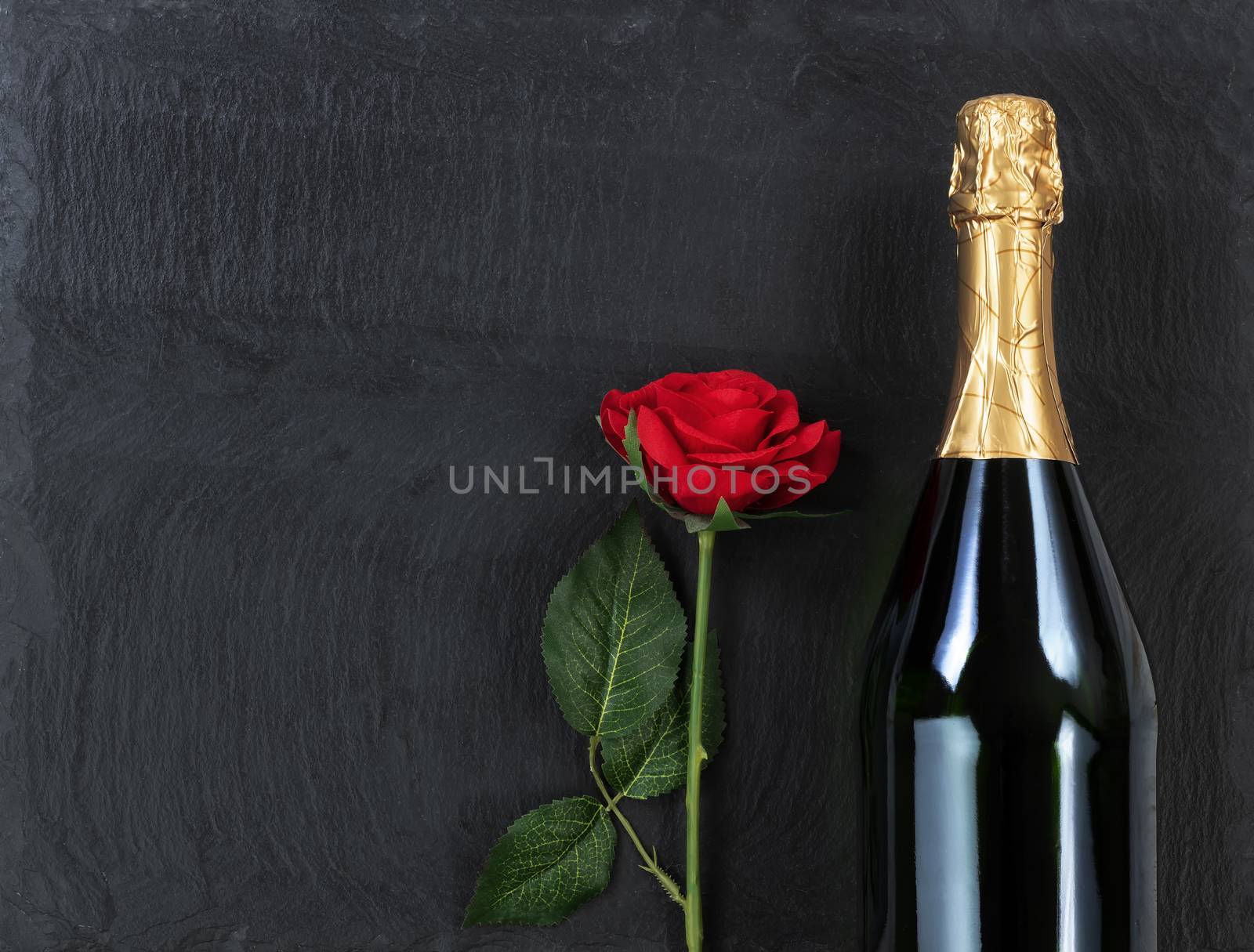 Anniversary background with single red rose and champagne on nat by tab1962