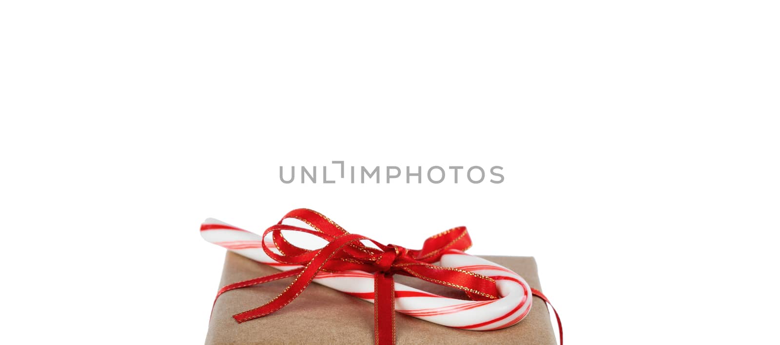 Top of Christmas brown gift box and candy cane isolated on pure  by tab1962