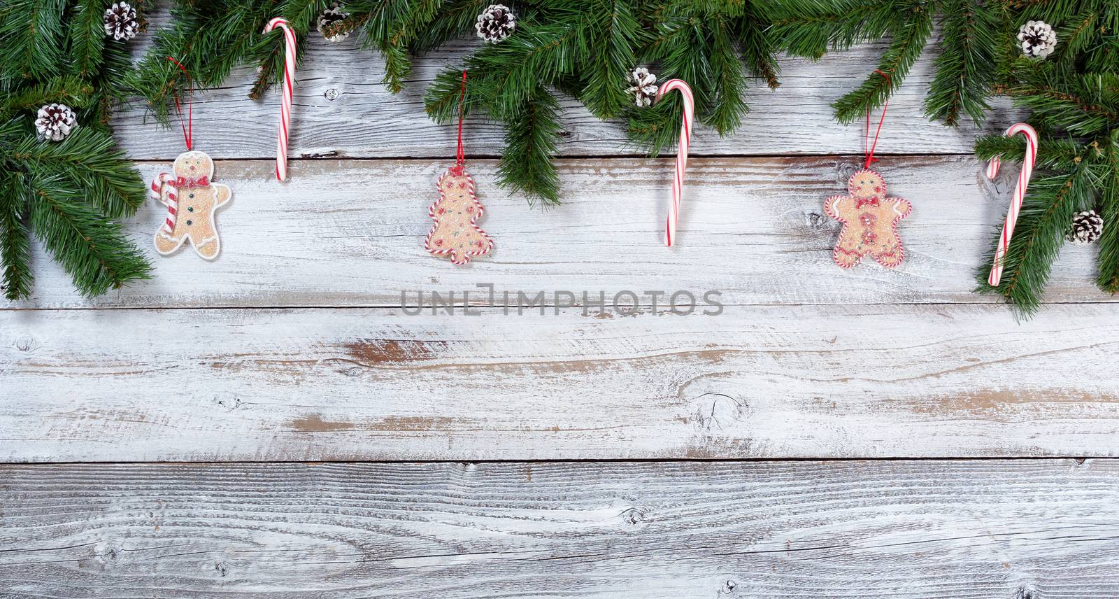 Christmas candy canes and cookie decorations on rustic wood in flat lay format

