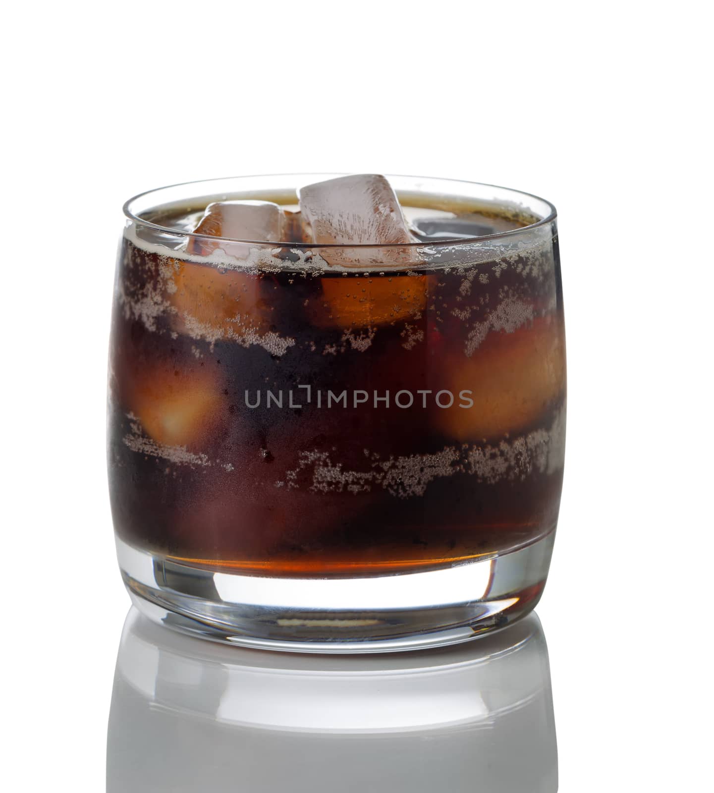 Freshly poured dark soda with ice in glass  by tab1962