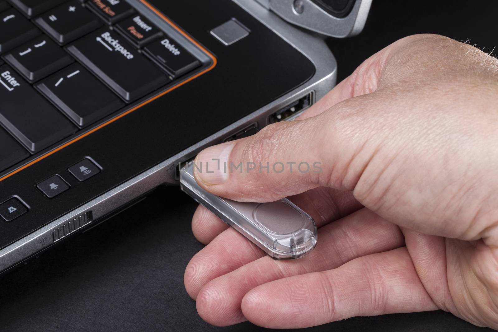 Hand inserting usb thumb drive into computer 
