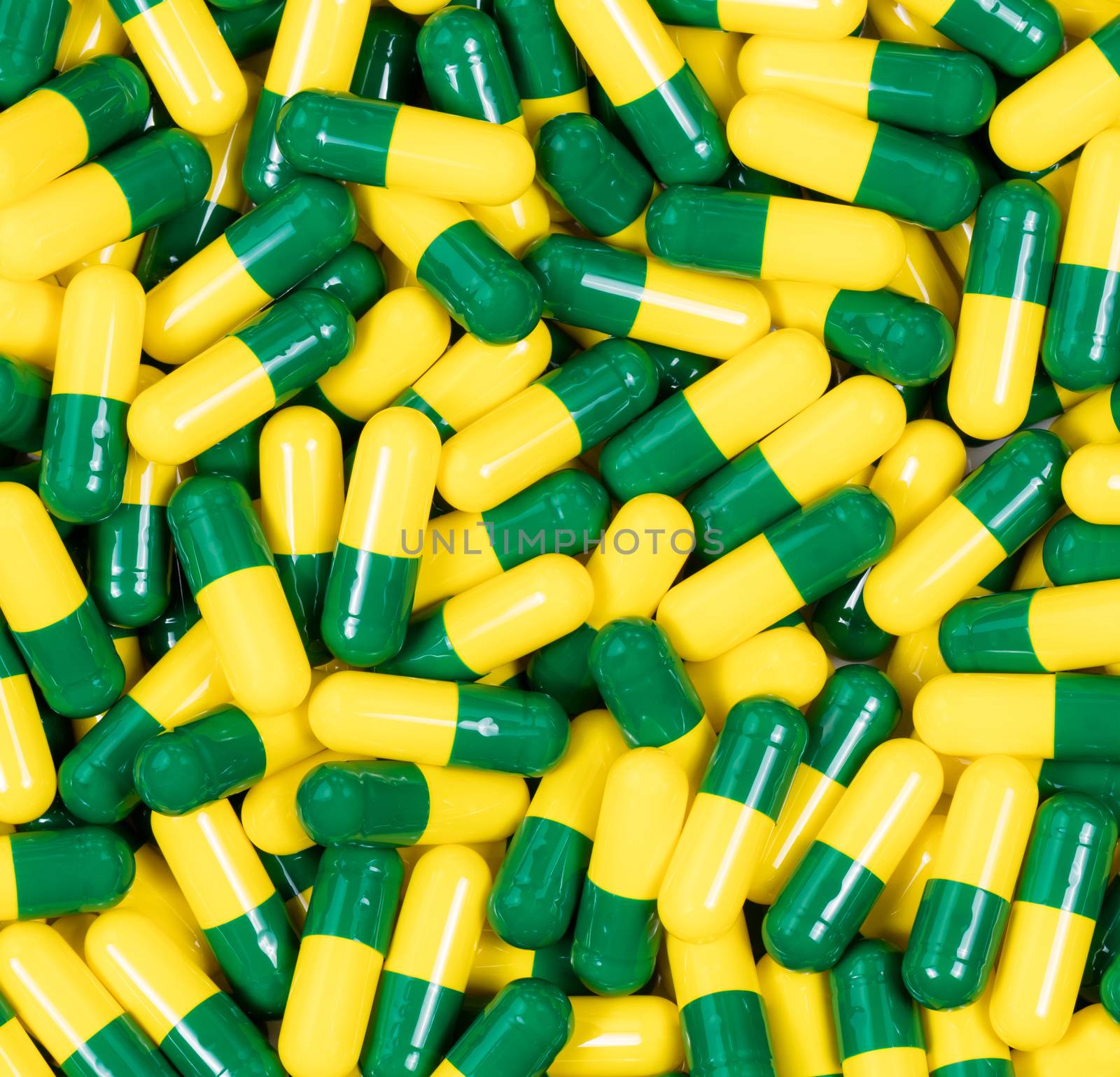 Medication capsules in green and yellow colors by tab1962