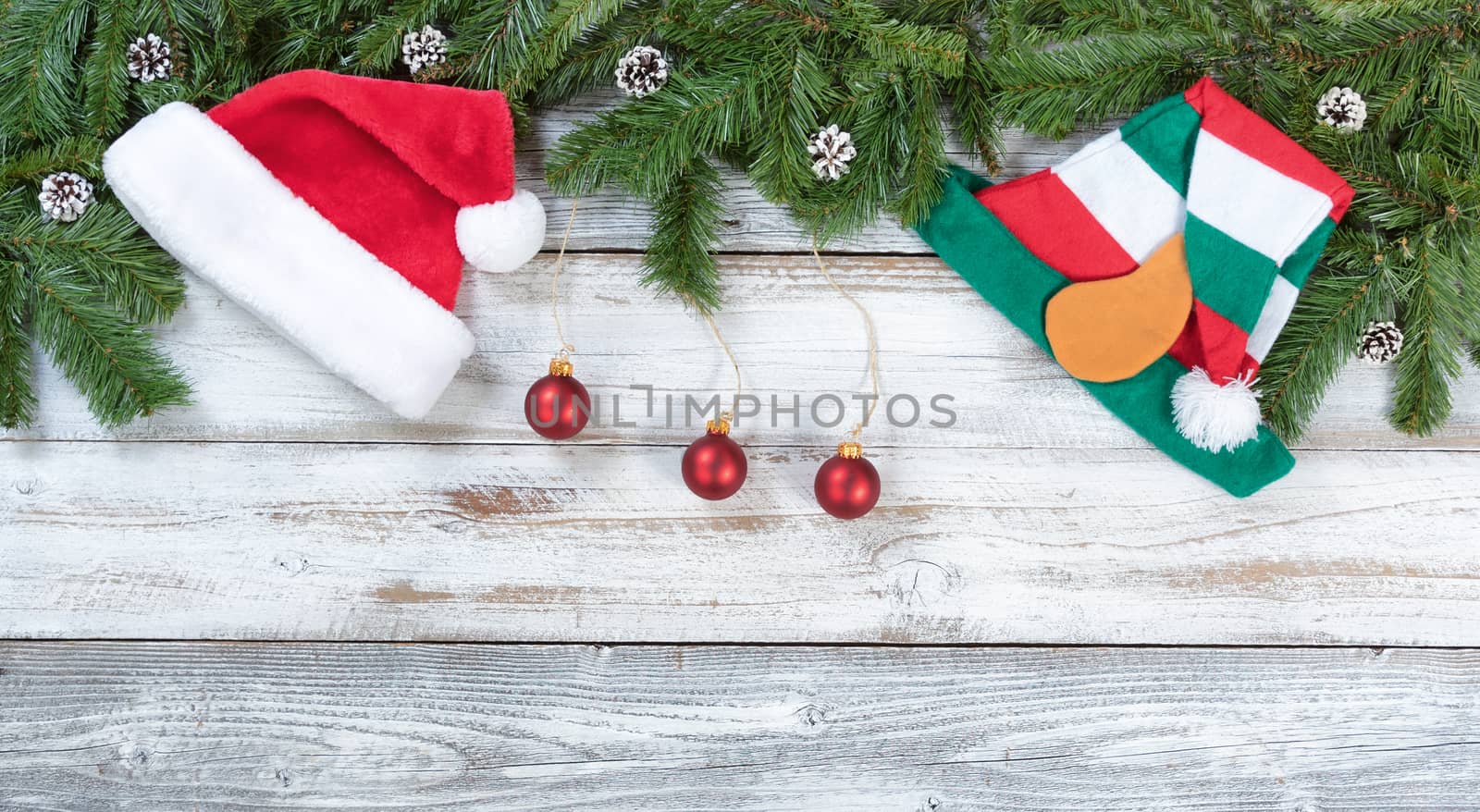 Top border of Christmas tree fir branches with traditional decorations in flat lay format