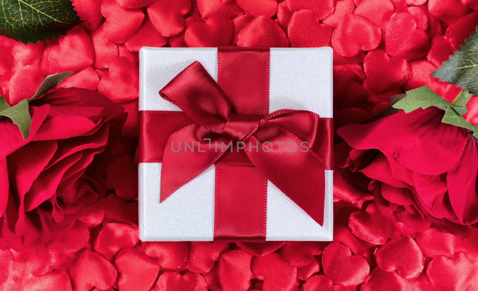 Valentine Gift box with hearts and roses in background 