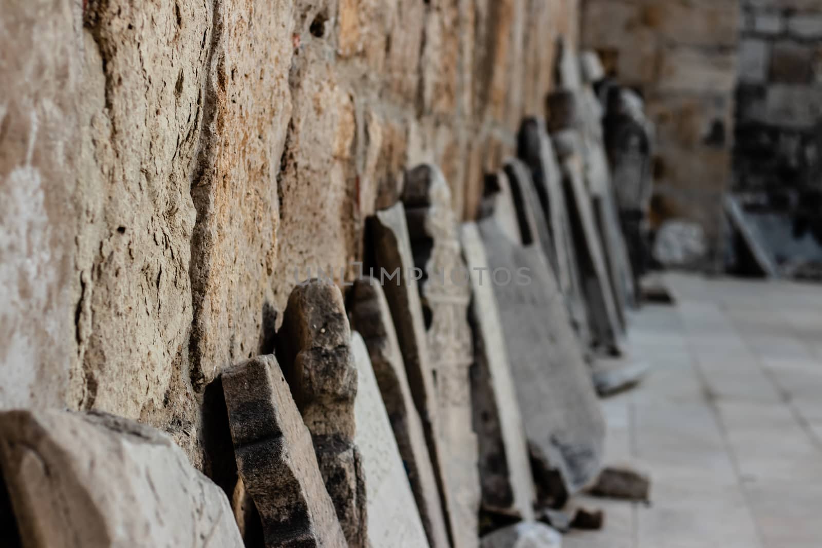 nice looking many tablets are lean to the church wall at ephesus - far tablets are blurry. photo has taken at izmir/turkey.