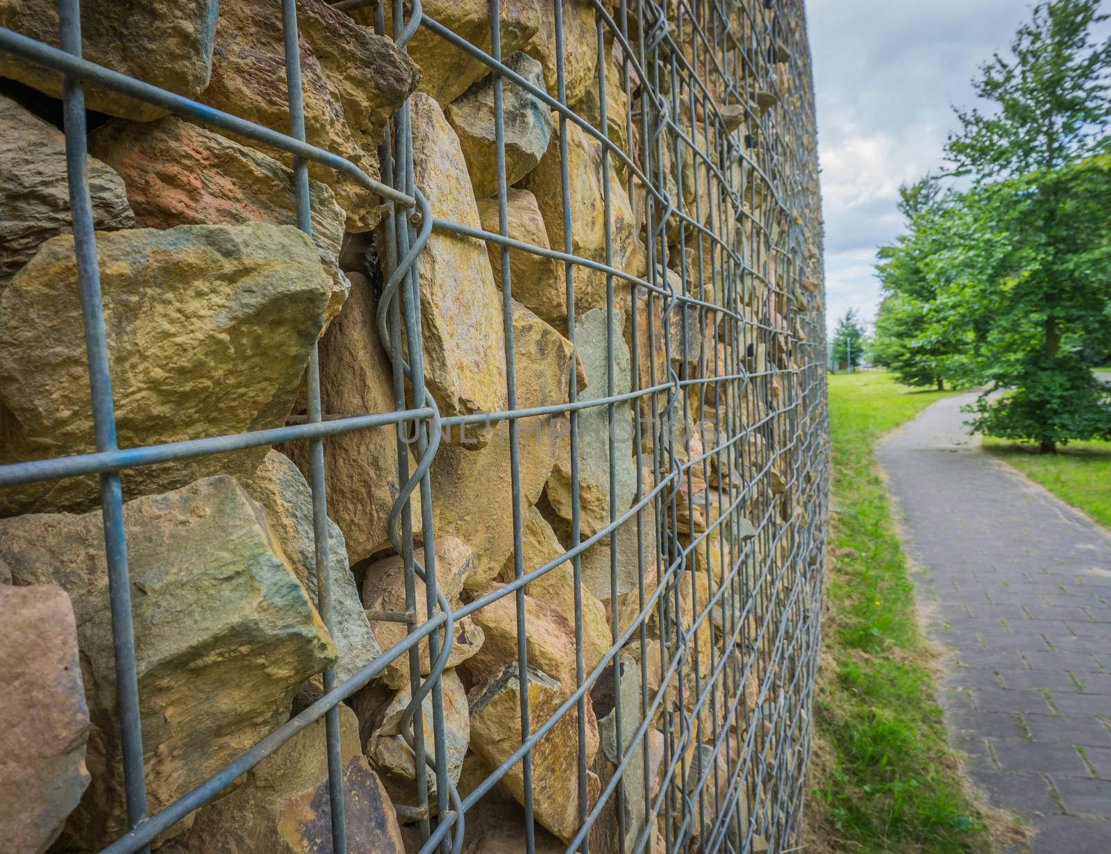 close up of basket filled with stones with road texture background by charlottebleijenberg