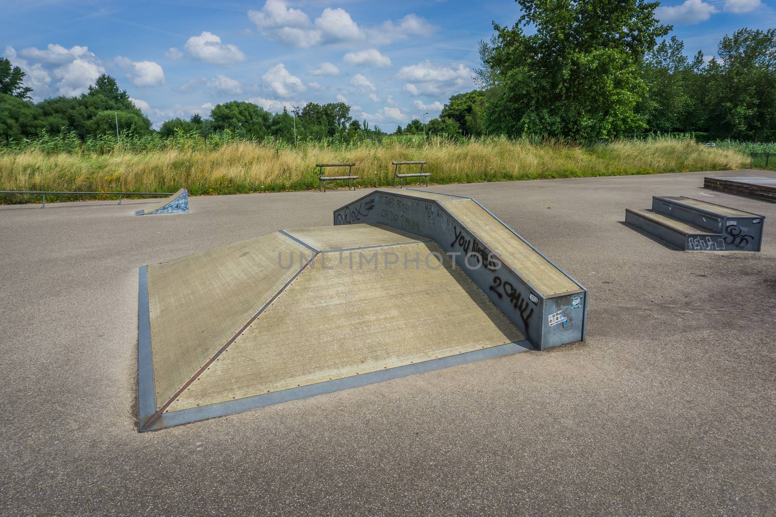 small skate ramp with grinding rail at the skaters park