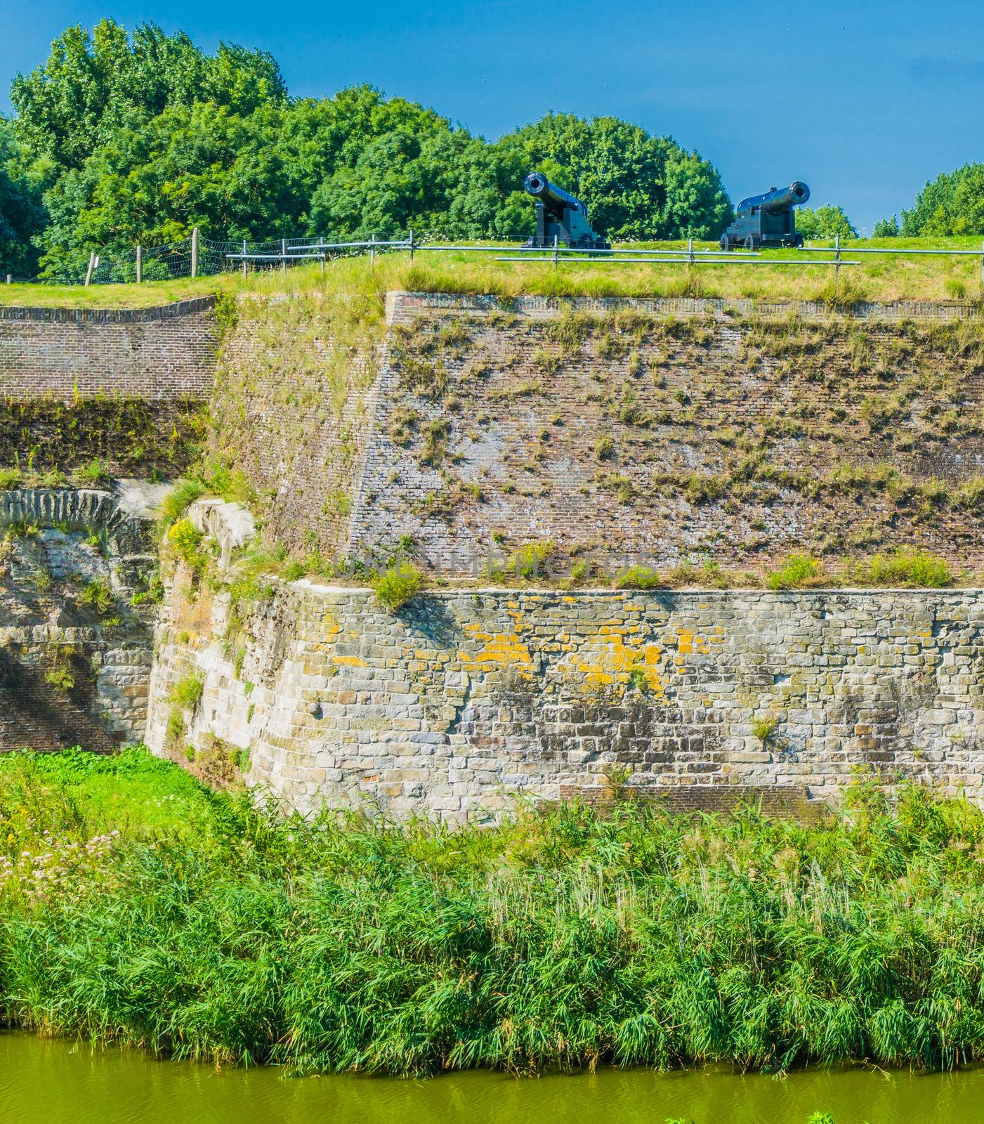 massive old stone defense wall with cannons