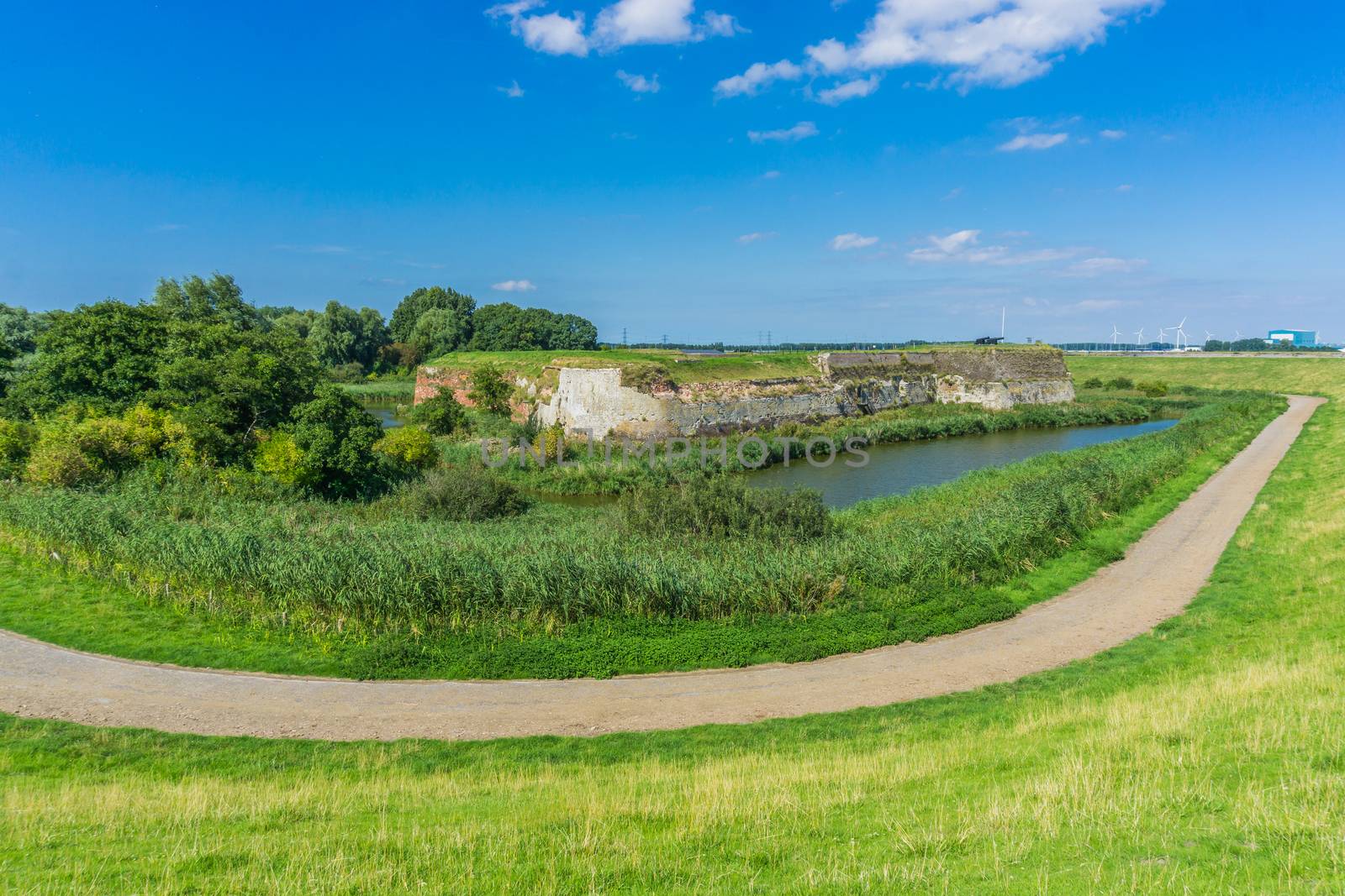 road with water landscape and big wall by charlottebleijenberg