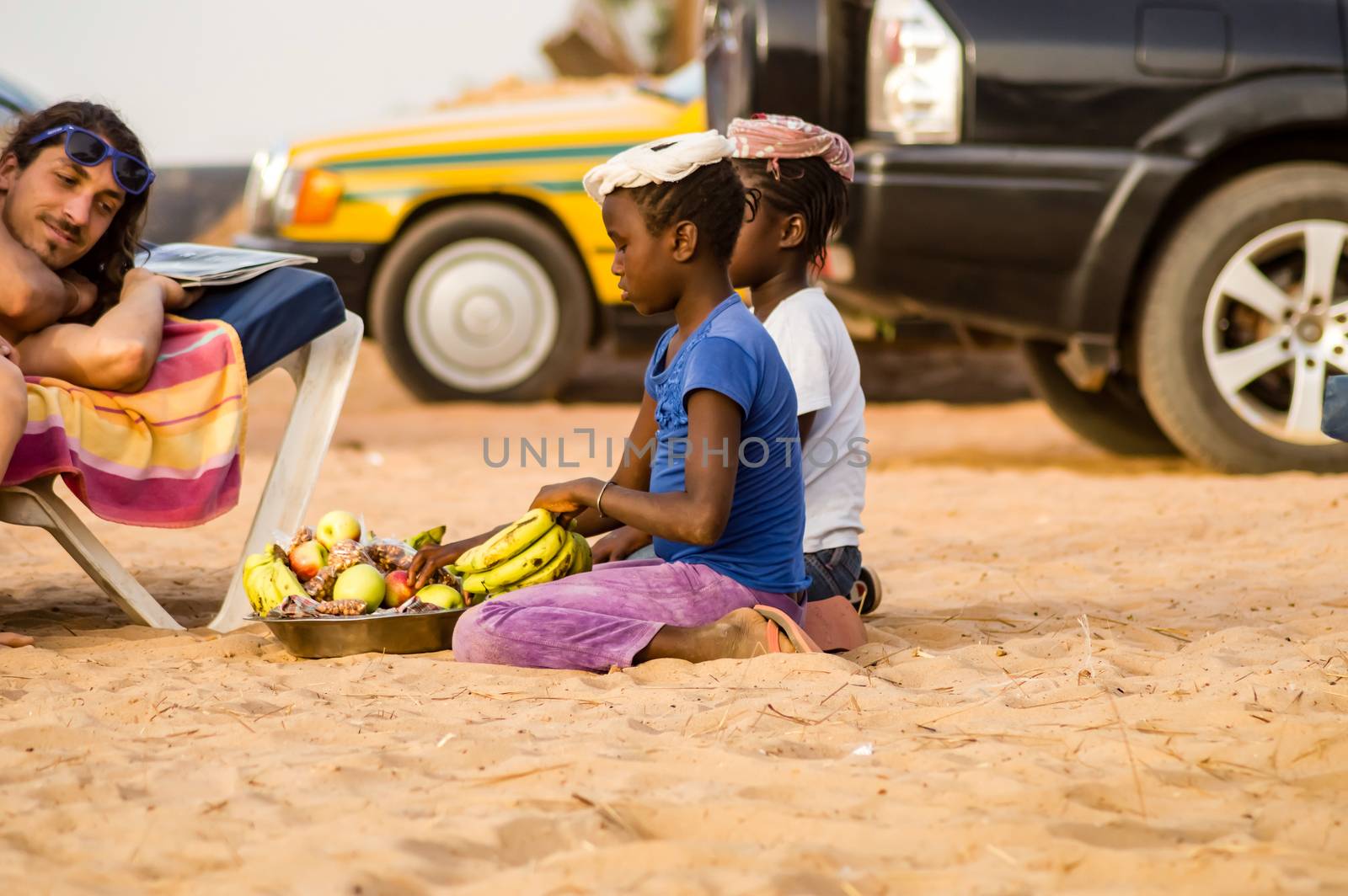 GAMBIE, BIJILO - 05 January 2020;Woman selling fruit in a basket by Philou1000