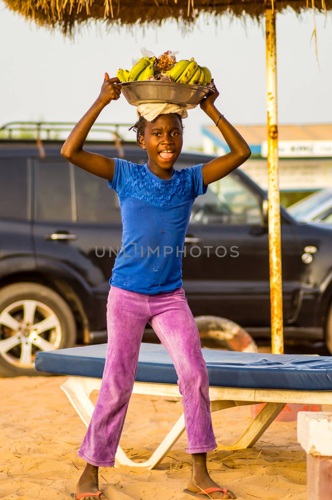 GAMBIE, BIJILO - 05 January 2020;Woman selling fruit in a basket by Philou1000