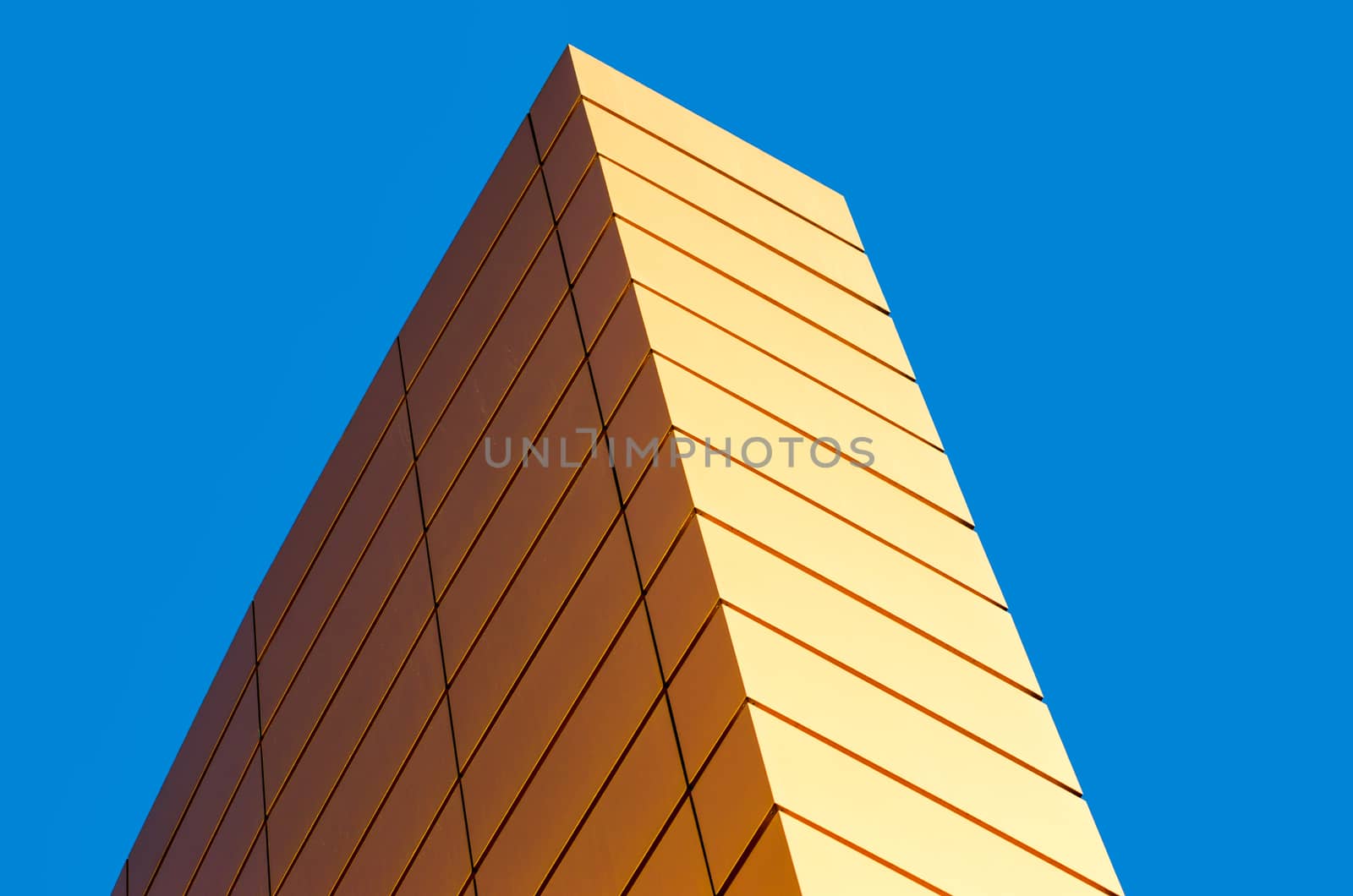 architectural abstract pattern fragment of a wall of a yellow modern building on a blue background