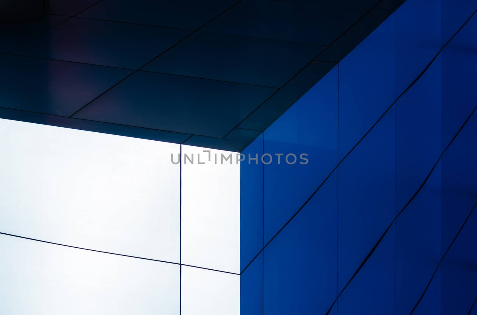 architectural abstract pattern fragment of a wall of blue modern building on a white background