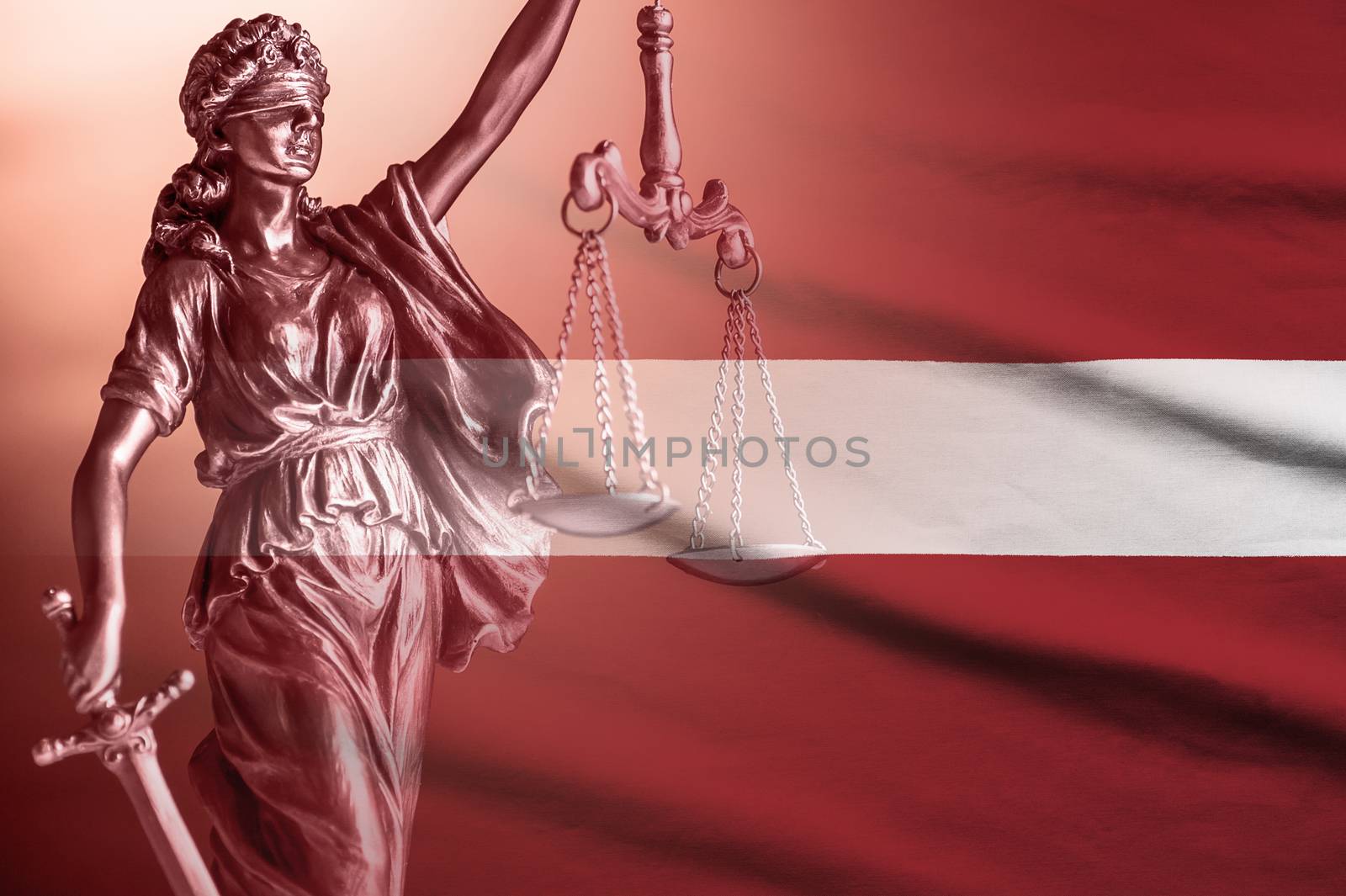 Flag of Latvia with figure of Justice holding up scales and sword conceptual of law enforcement and impartiality with copy space