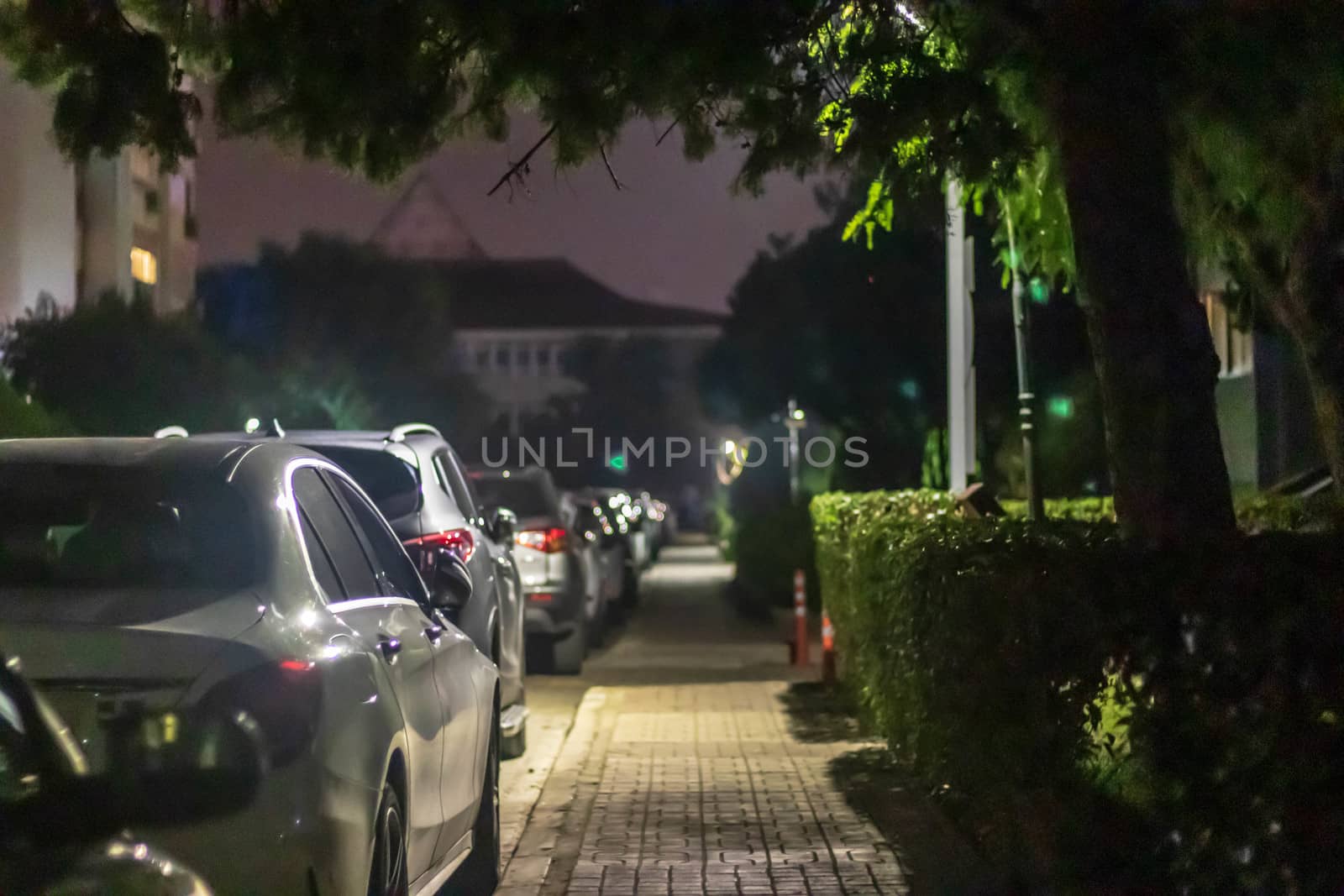 a nice looking narrow night shoot from sidewalk - there is many cars and street lights. photo has taken at izmir/turkey.