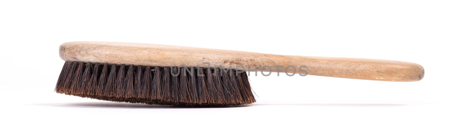 Old hair brush with some hair in it, isolated on white
