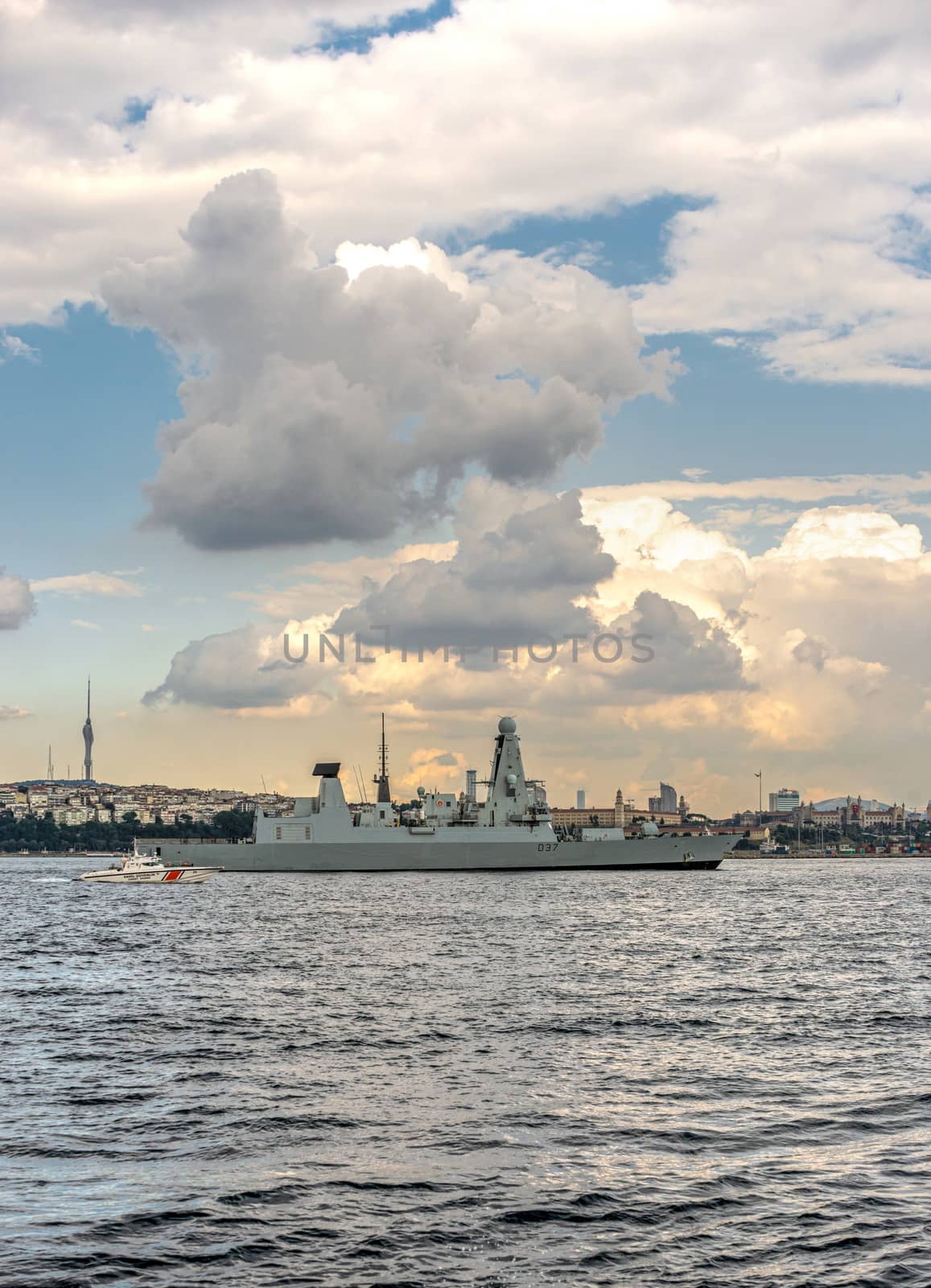 Istambul, Turkey – 07.12.2019. Passage of a warship through the Bosphorus Strait on a summer evening