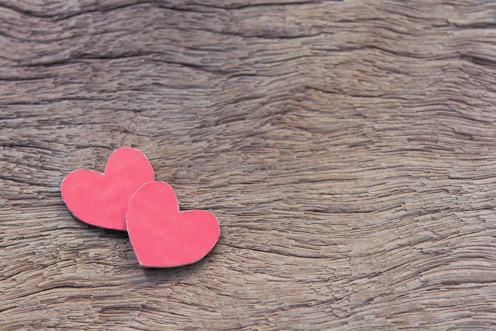 Valentines Day background with red heart shape on dark wooden background with copy space
