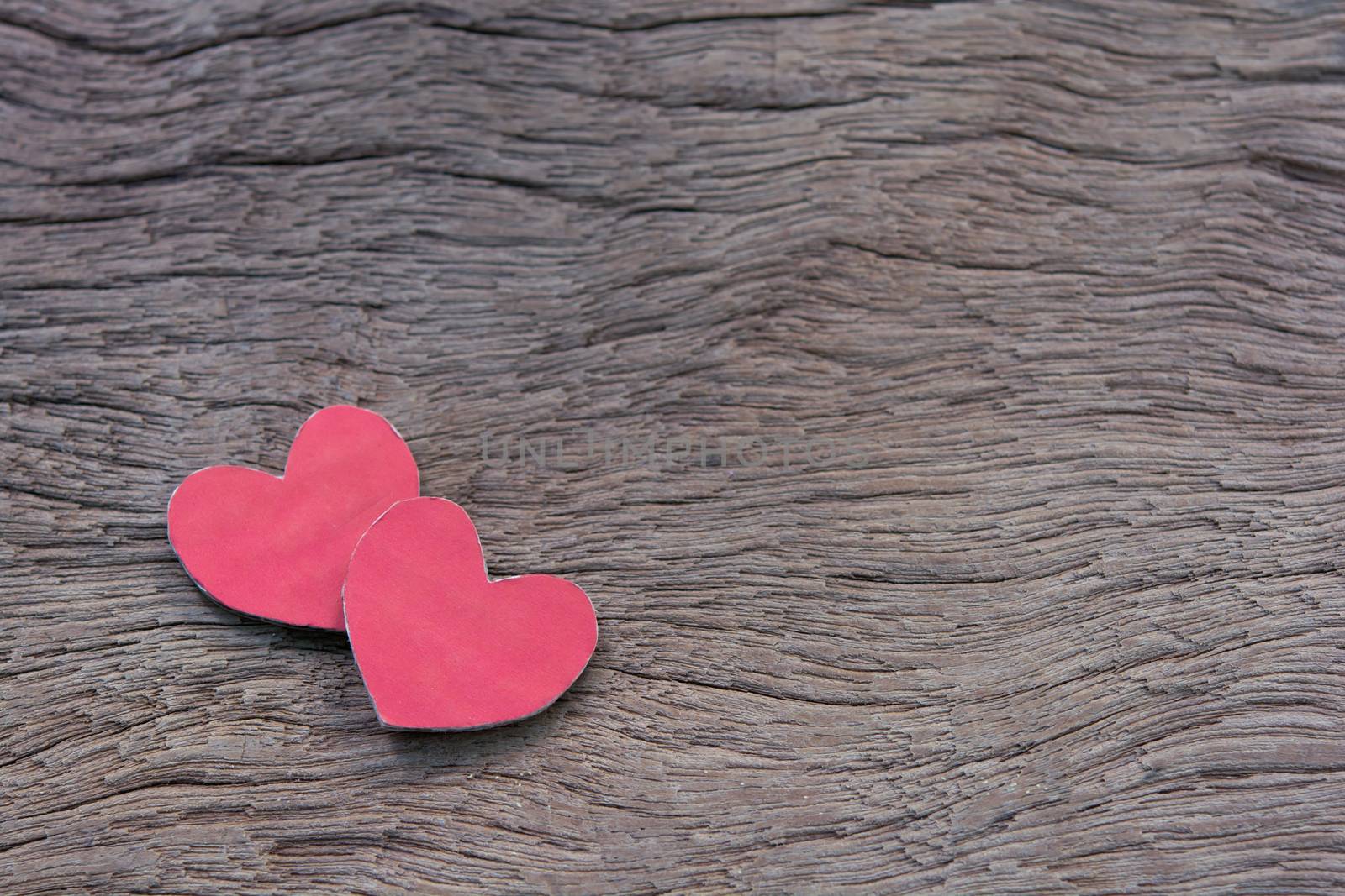 Valentines Day background with red heart shape on dark wooden background with copy space
