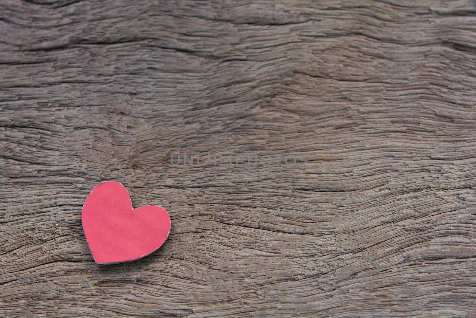 Valentines Day background with red heart shape on dark wooden background with copy space
