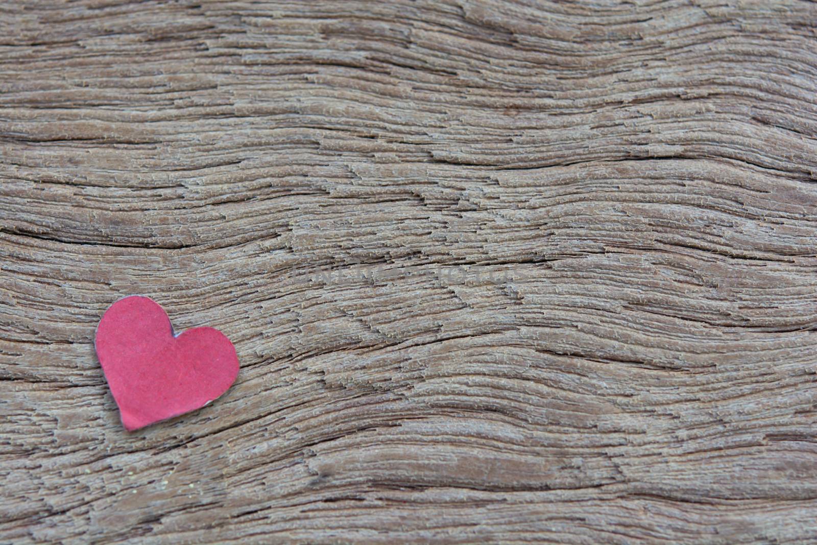 Valentines Day background with red heart shape on dark wooden background with copy space
