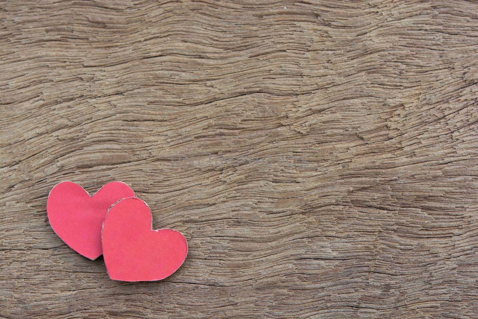 Valentines Day background with red heart shape on dark wooden background with copy space
