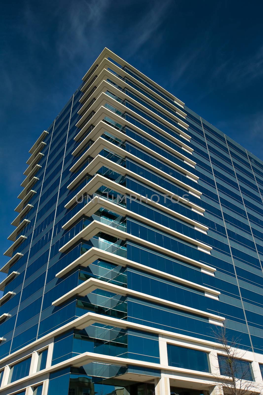 A blue glass office building with white corners