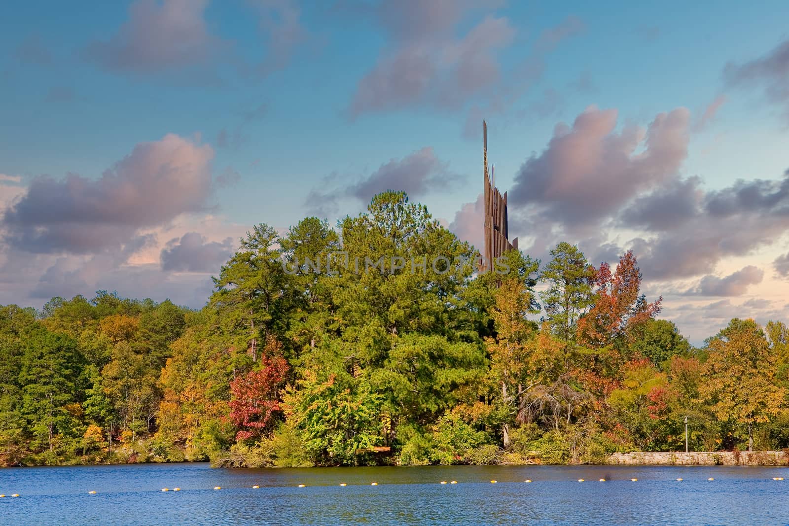 A carillon beside a lake in the pine trees