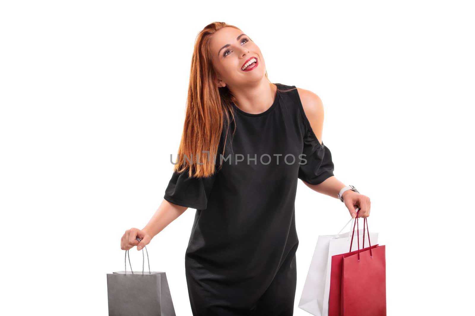Sale, shopping concept. Excited beautiful young woman with shopping bags in both hands, isolated on white background.