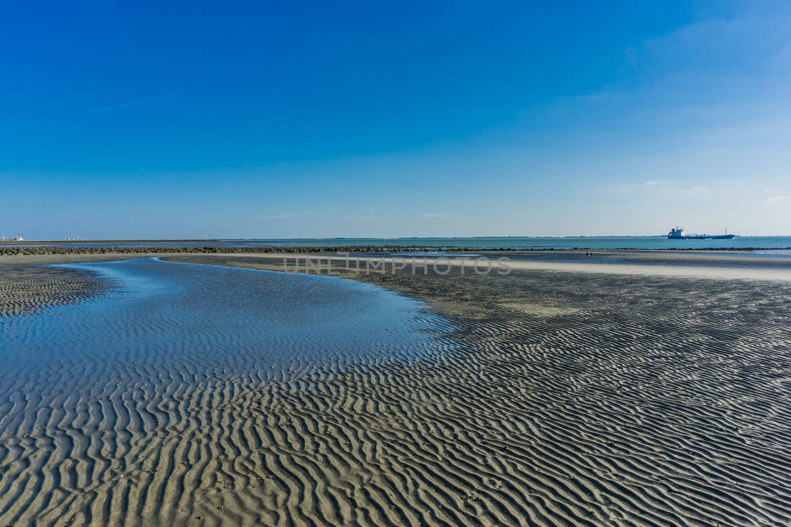 puddle split from the sea on a sandy beach