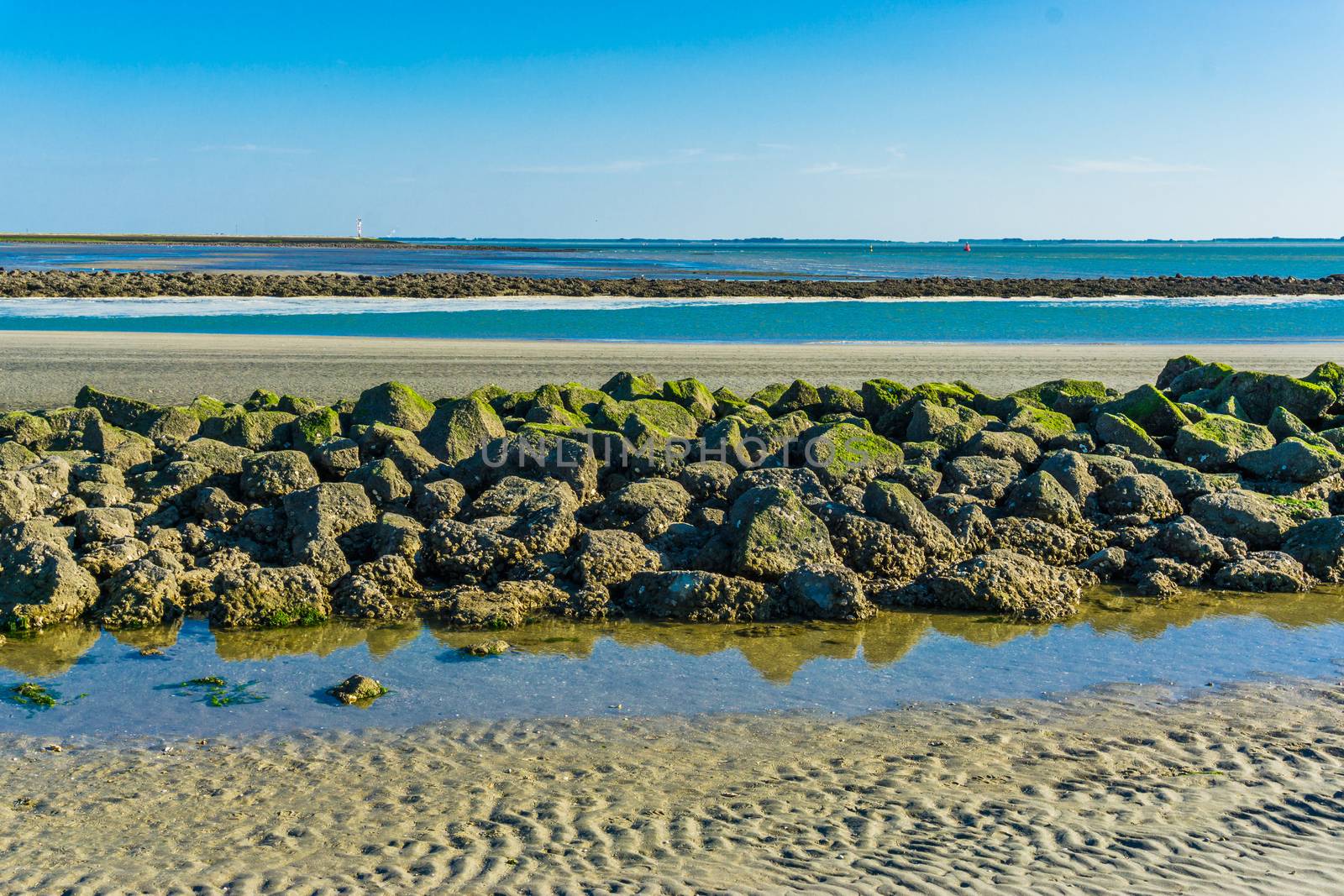 beautiful beach landscape with a line of rocks stacked