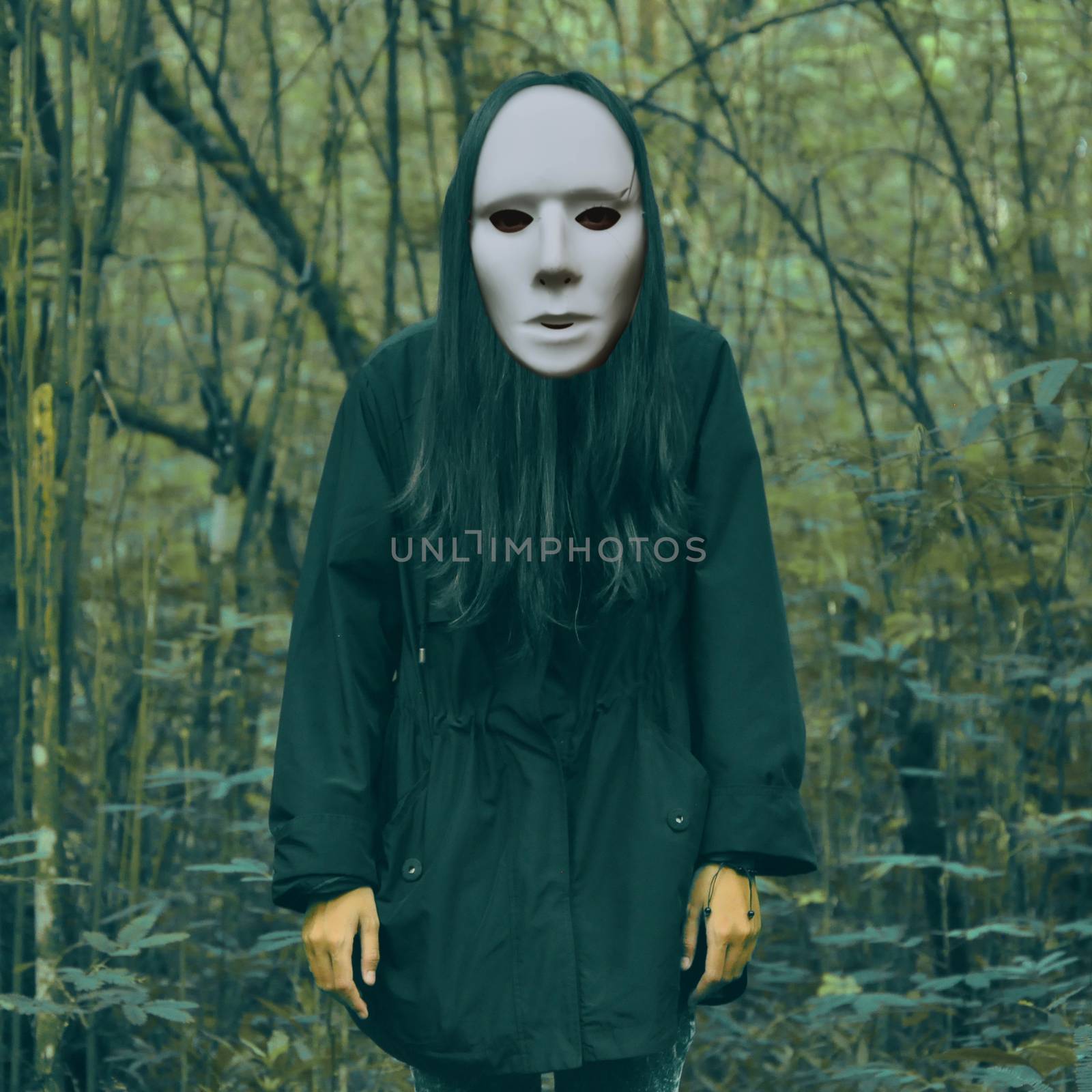Halloween scary masked women in a creepy forest landscape