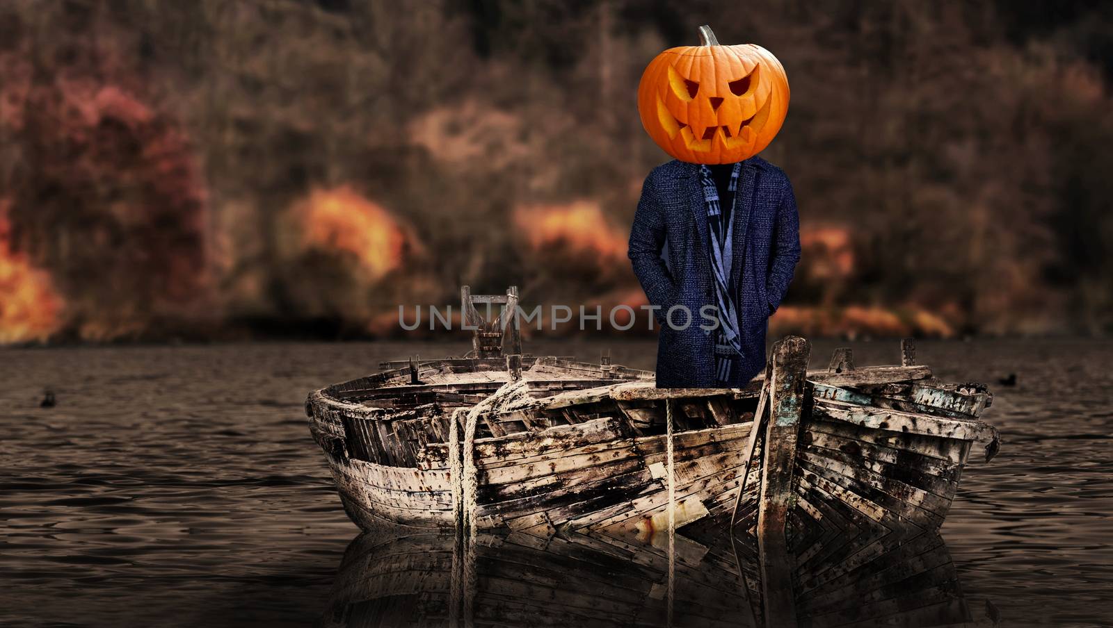 Halloween scary pumpkin headed ghost person on a boat floating by charlottebleijenberg