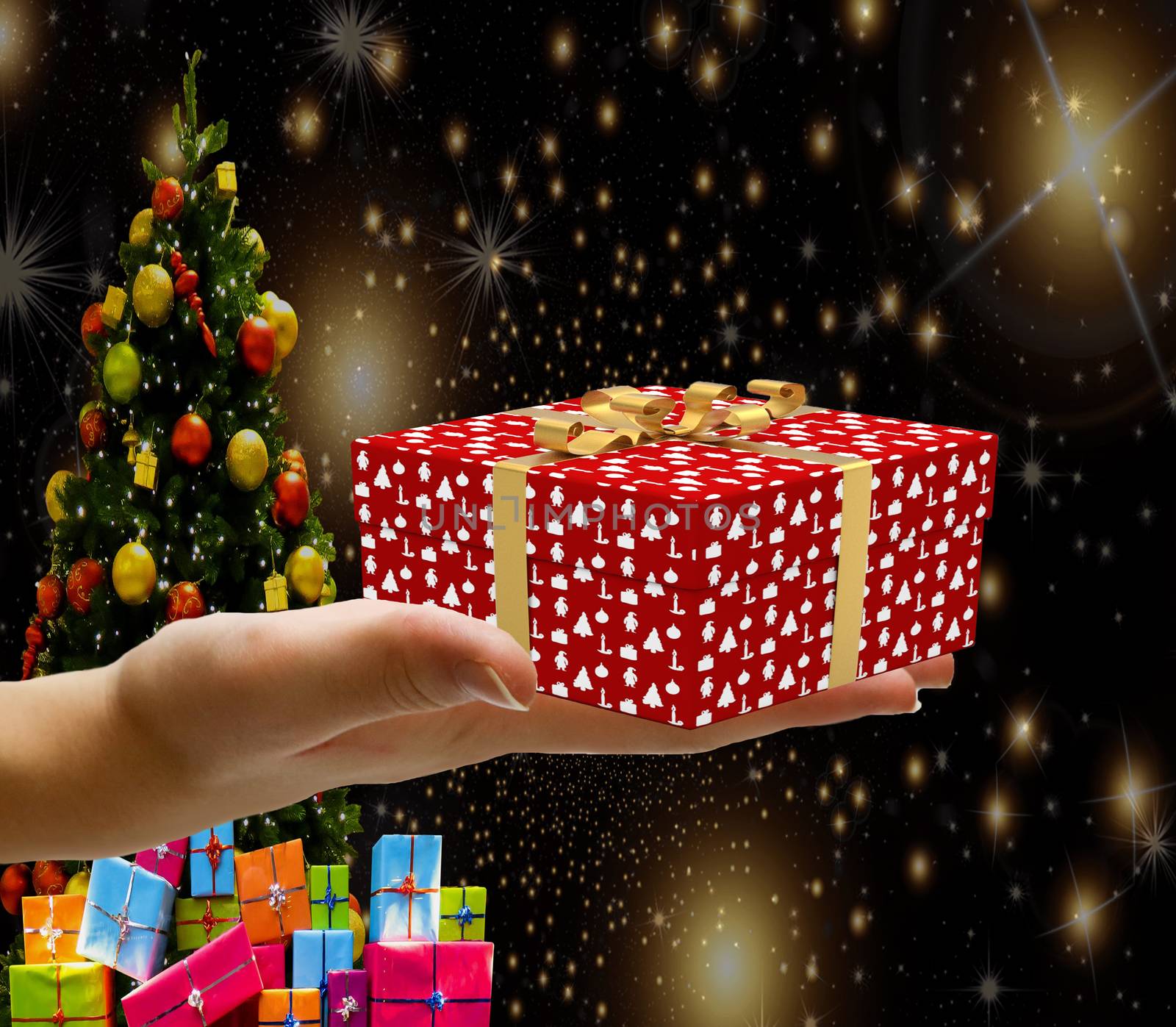 Christmas concept a hand holding a decorated wrapped christmas present box isolated on a christmas background with stars a tree and gifts by charlottebleijenberg