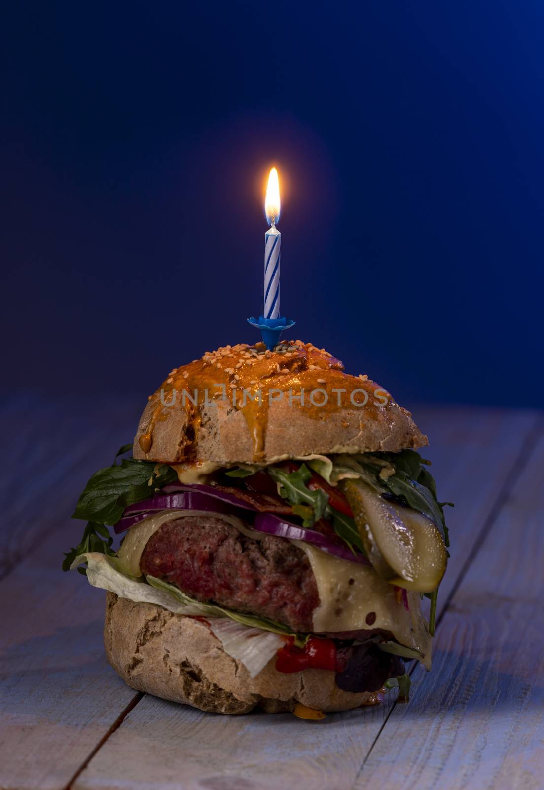 home made cheeseburger on dark wood