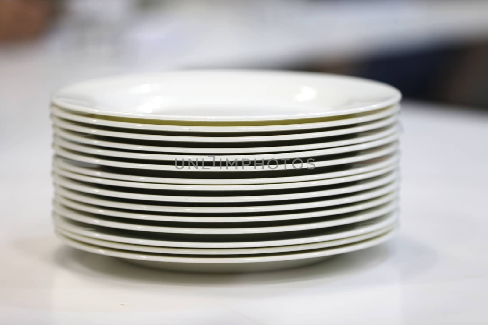 A stack of white plates. by Sviatlana