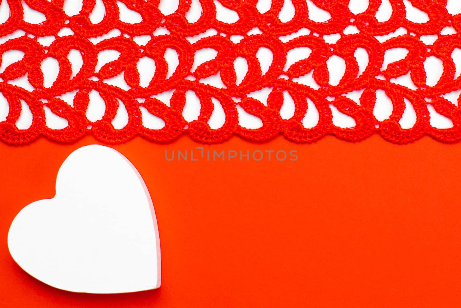 White and red wooden hearts on a red and white background. Blank for the designer. Valentines day concept. Greeting card. Valentine's Day. Copy space.