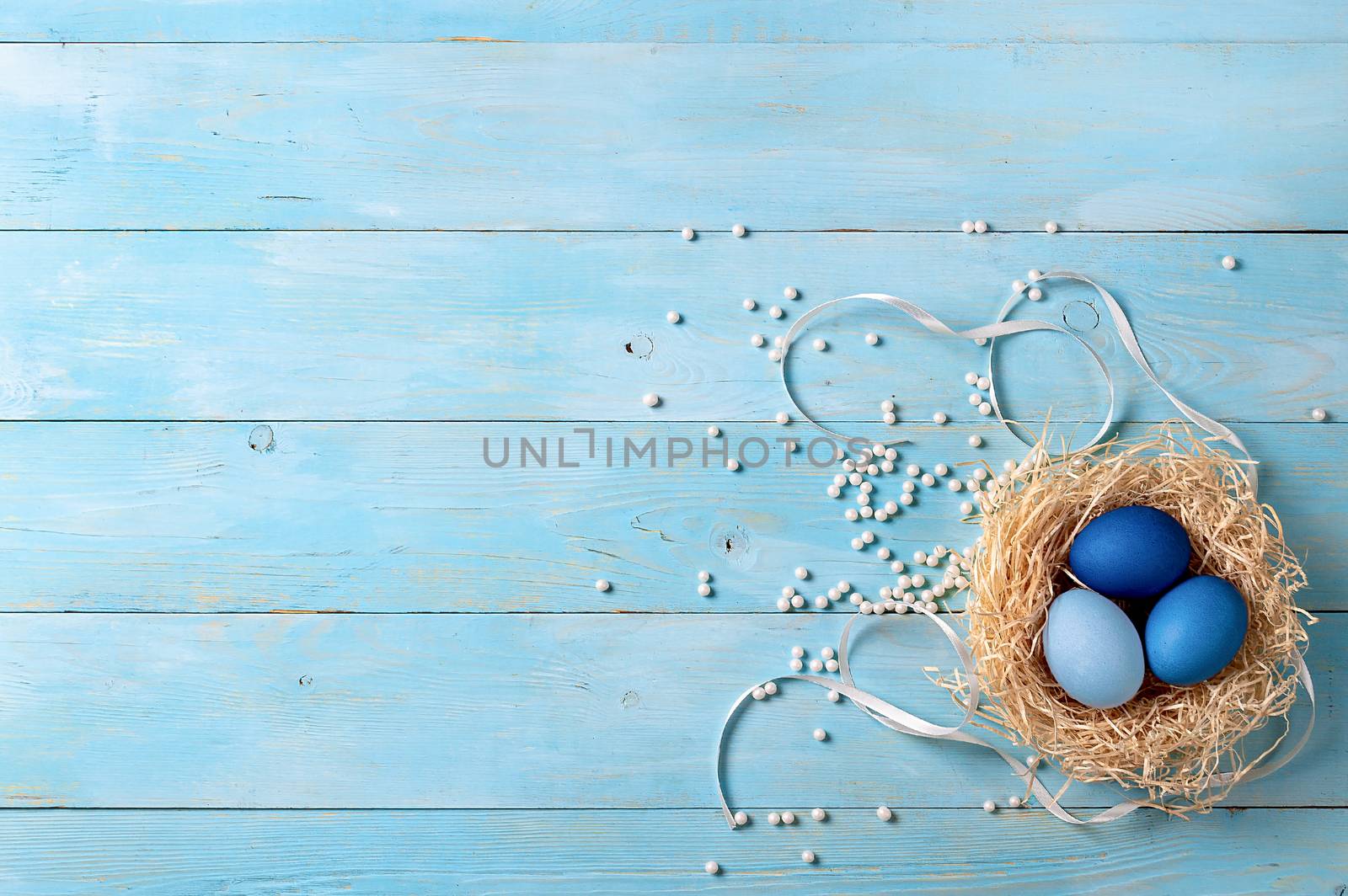 Easter concept. Ombre eggs in blue colors on blue wooden background with copy space for text. Top down view or flat lay. Classic blue colors in Easter 2020
