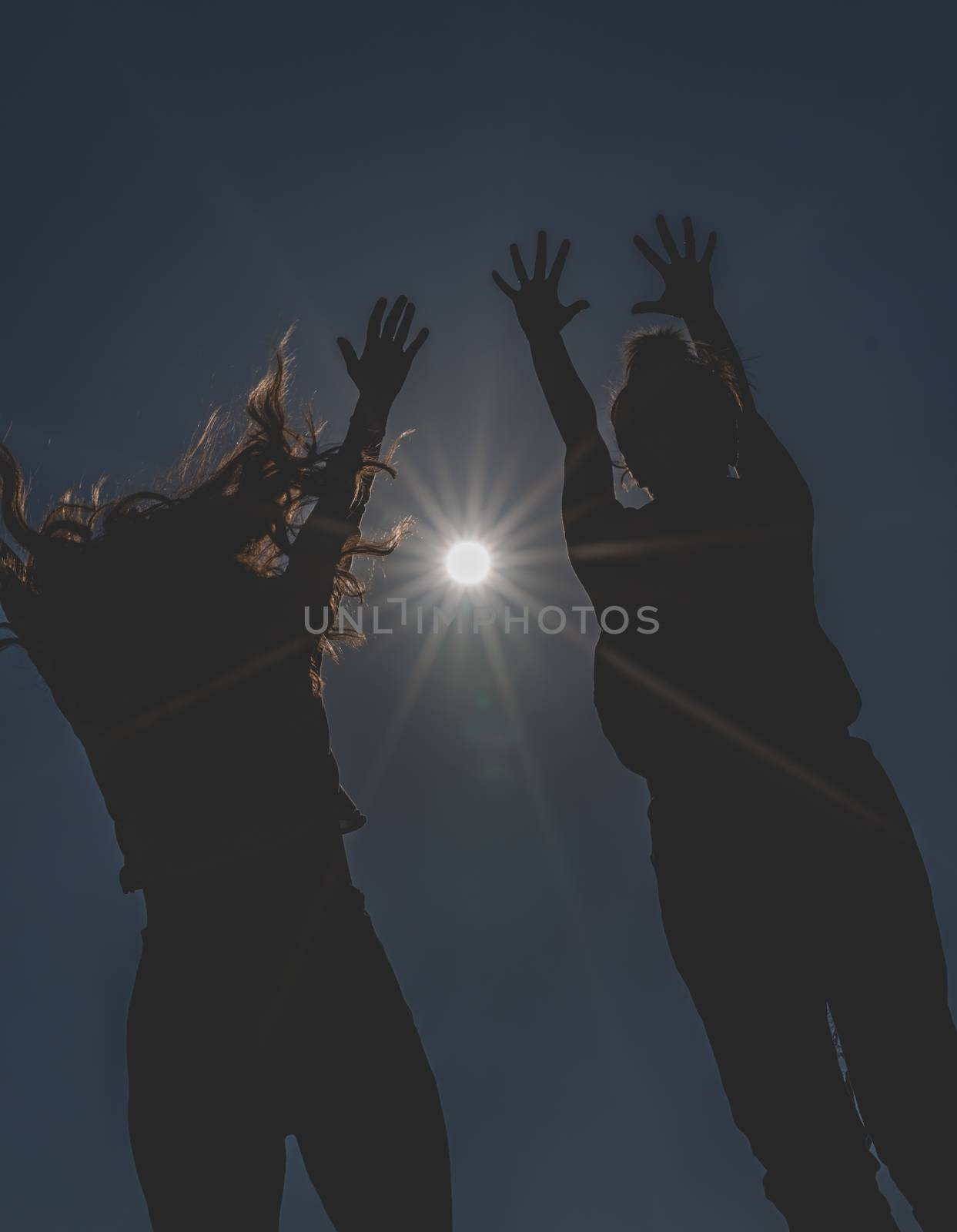 Dark and low angle image of happy girls.