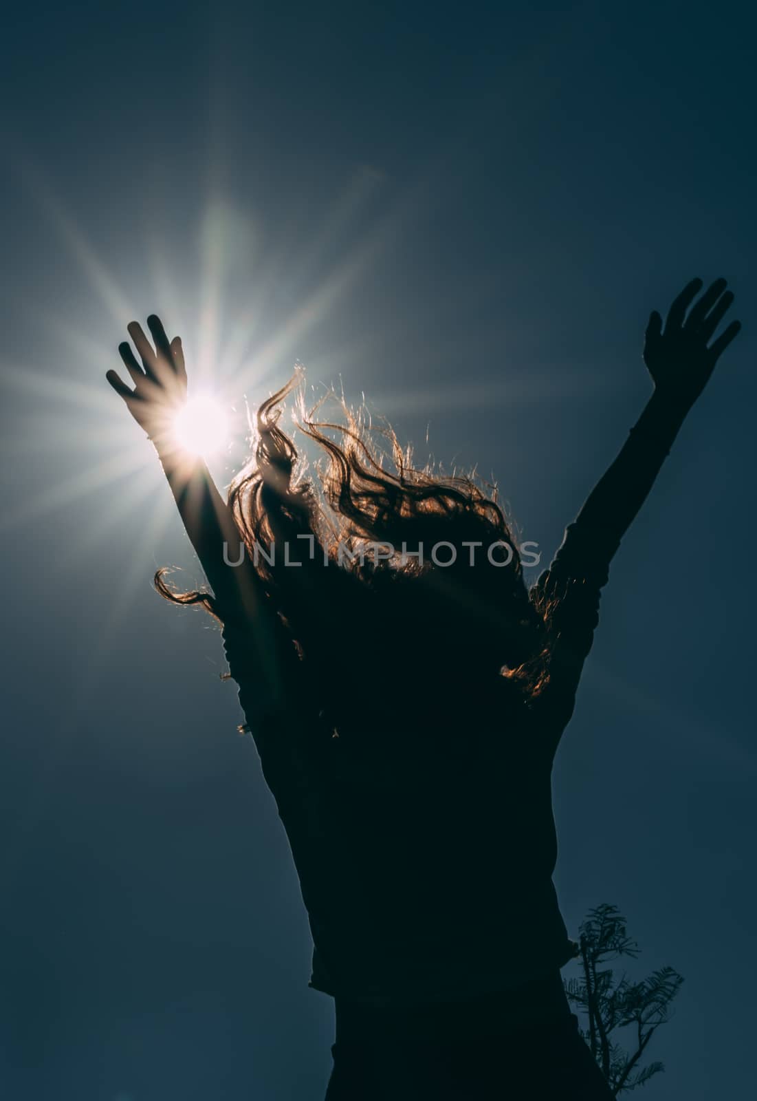 Dark and low angle image of happy girl.