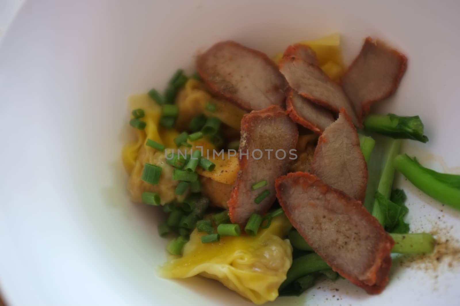 Wantan egg noodles and sliced roasted red pork . Asian street food   by Hepjam