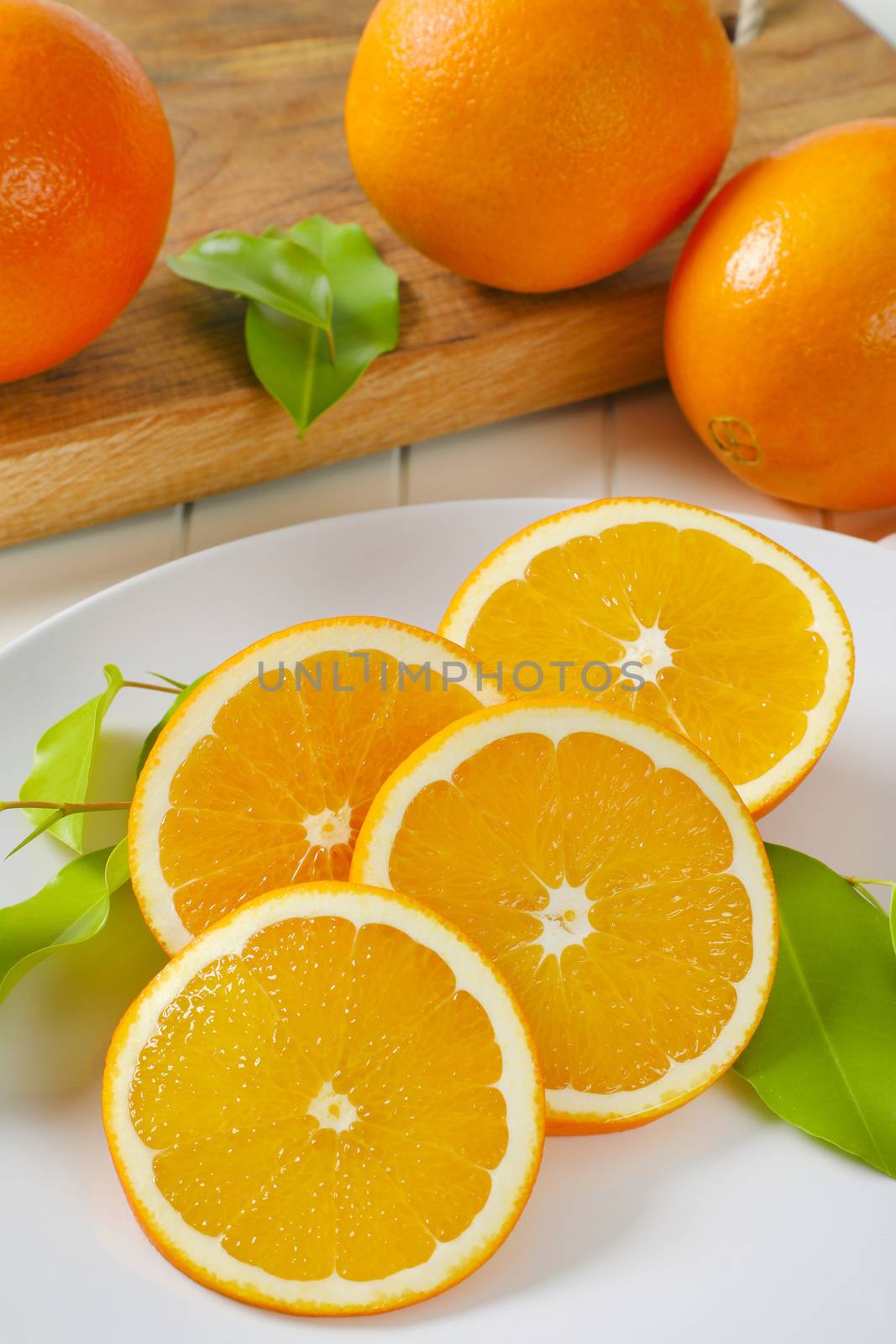 Fresh orange slices on white plate