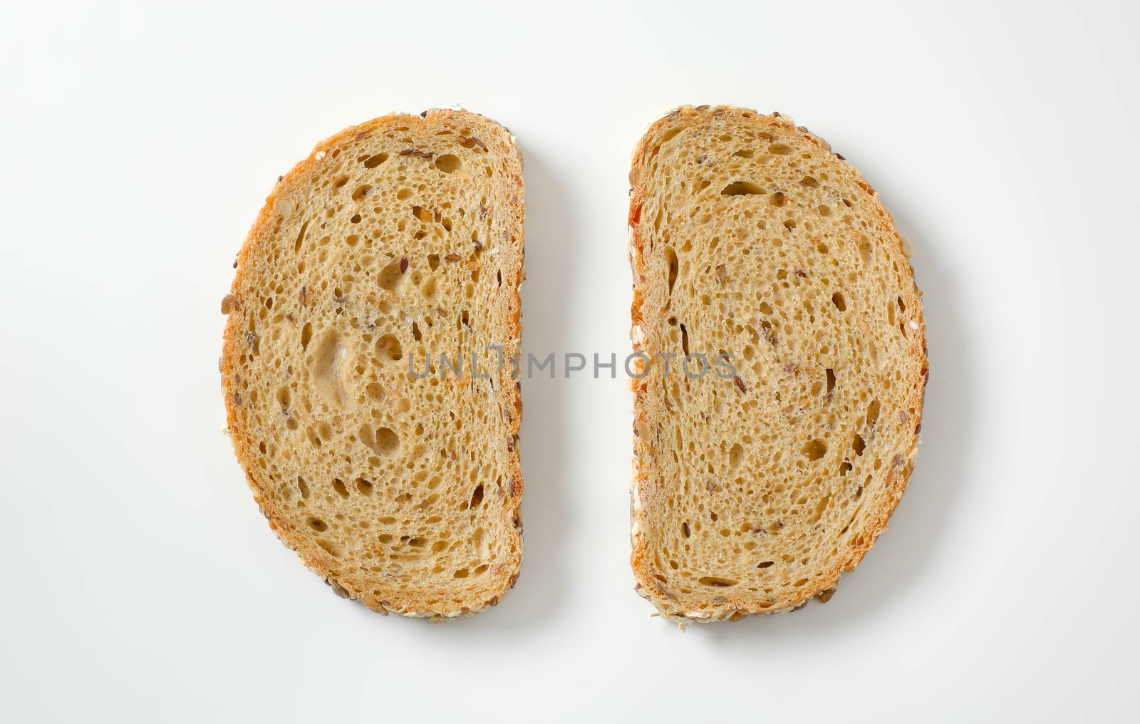Two slices of whole grain bread by Digifoodstock