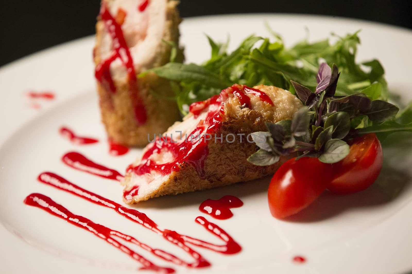 On a white plate, meat in breadcrumbs of sesame, arugula, tomato, basil and ketchup. by Sviatlana