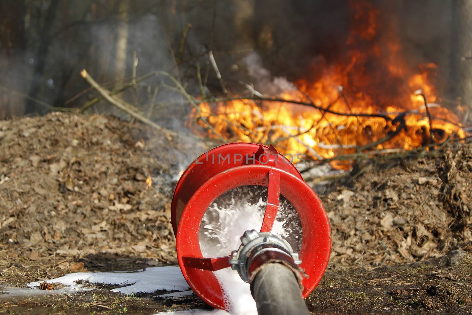 The fireman's hand holds a fire hose to extinguish a fire.Extinguish the fire. Fire hose