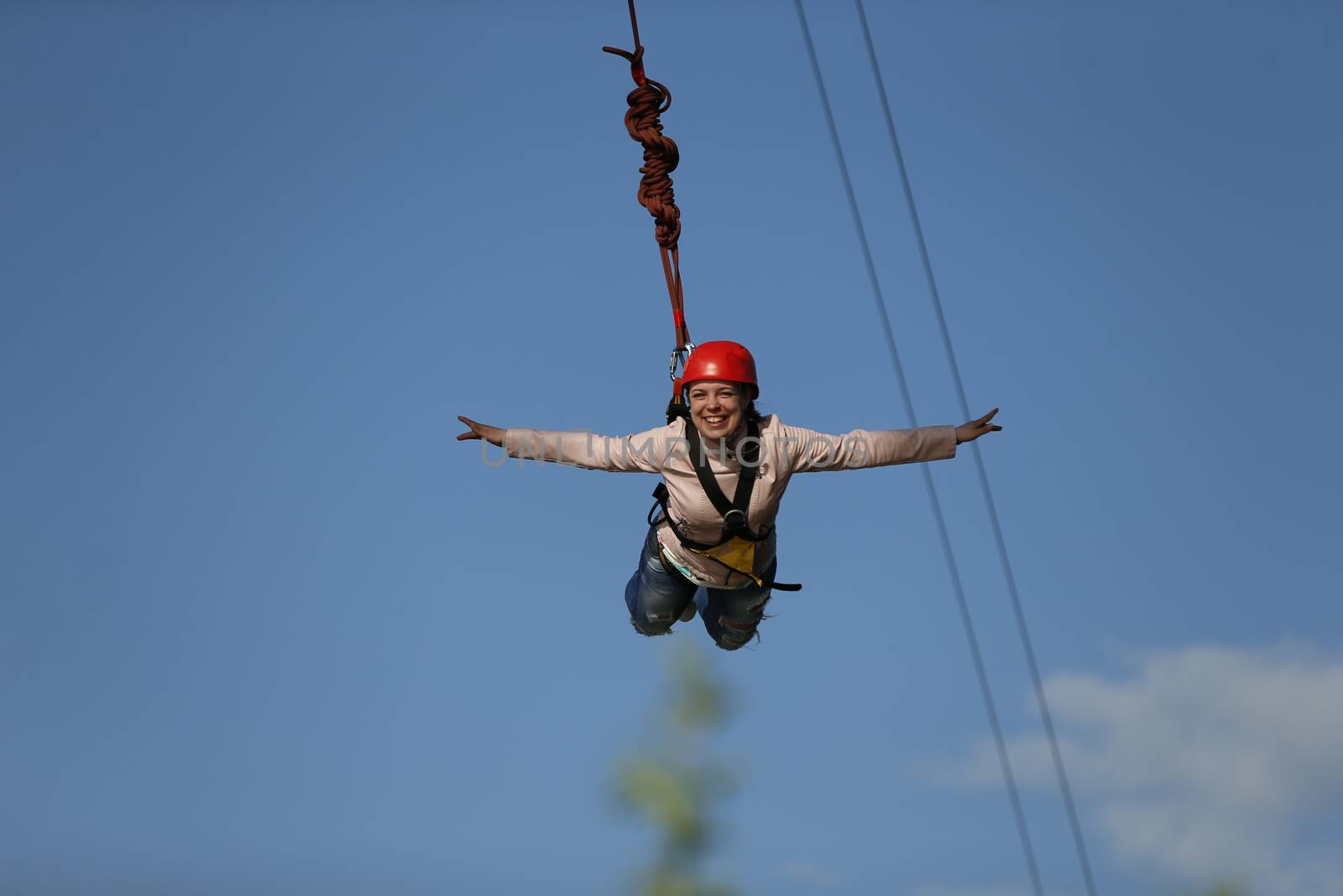 The brave girl jumped from the bridge and flies in the sky.Engage in ropejumping.Dangerous hobbies