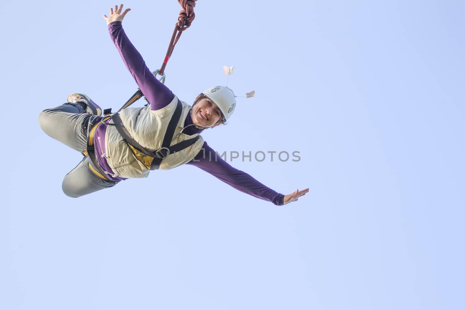 A woman practicing extreme sports.Dangerous hobby.Jump from the bridge