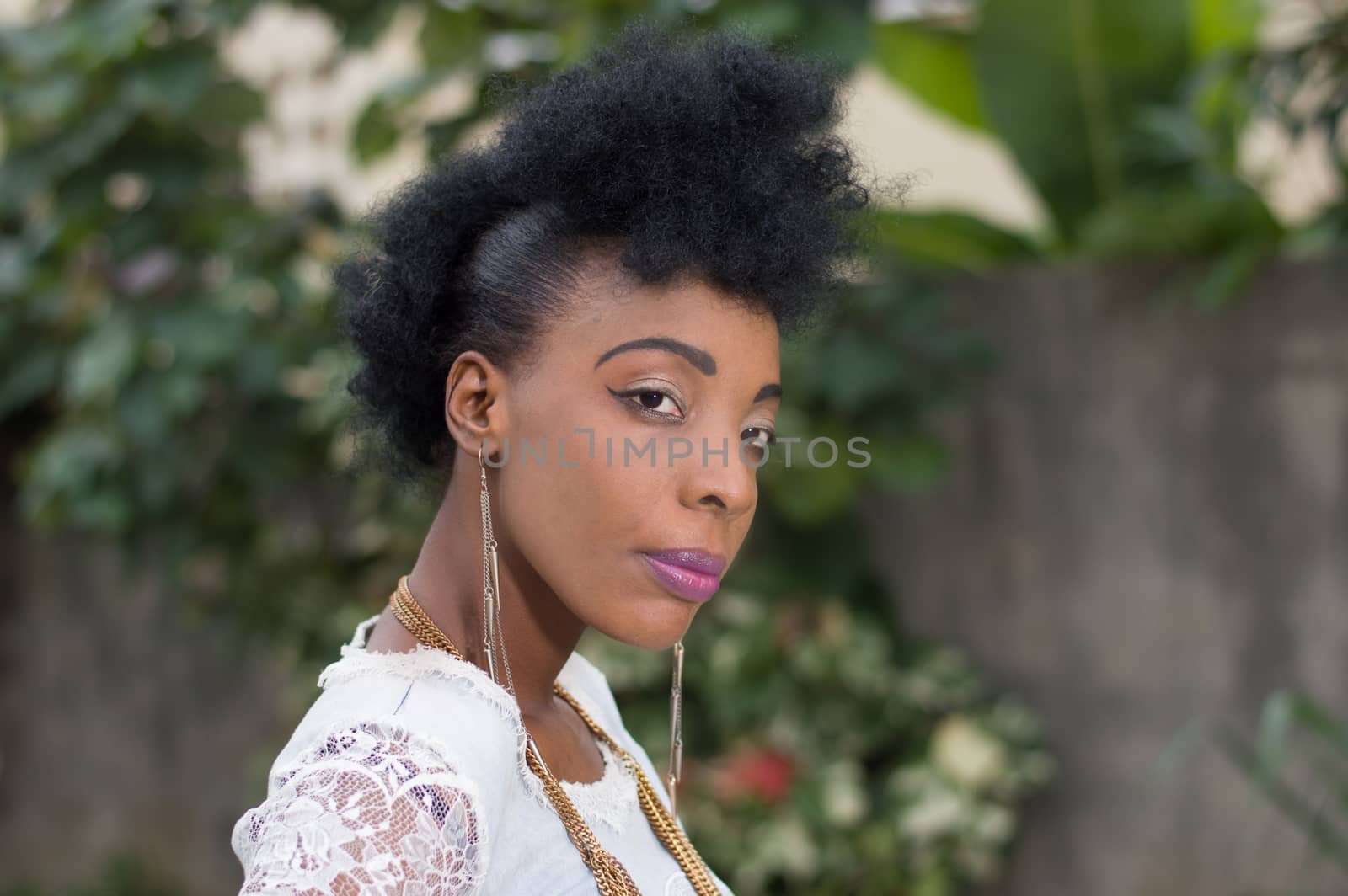 Portrait of young African woman posing in a garden.