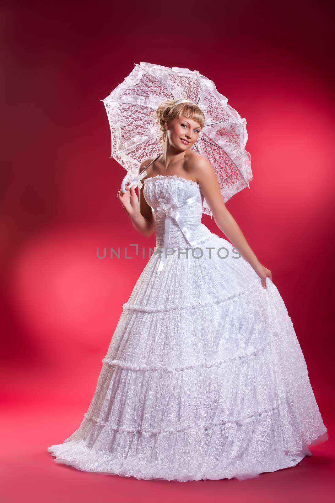 Young Woman in a wedding dress on a studio background