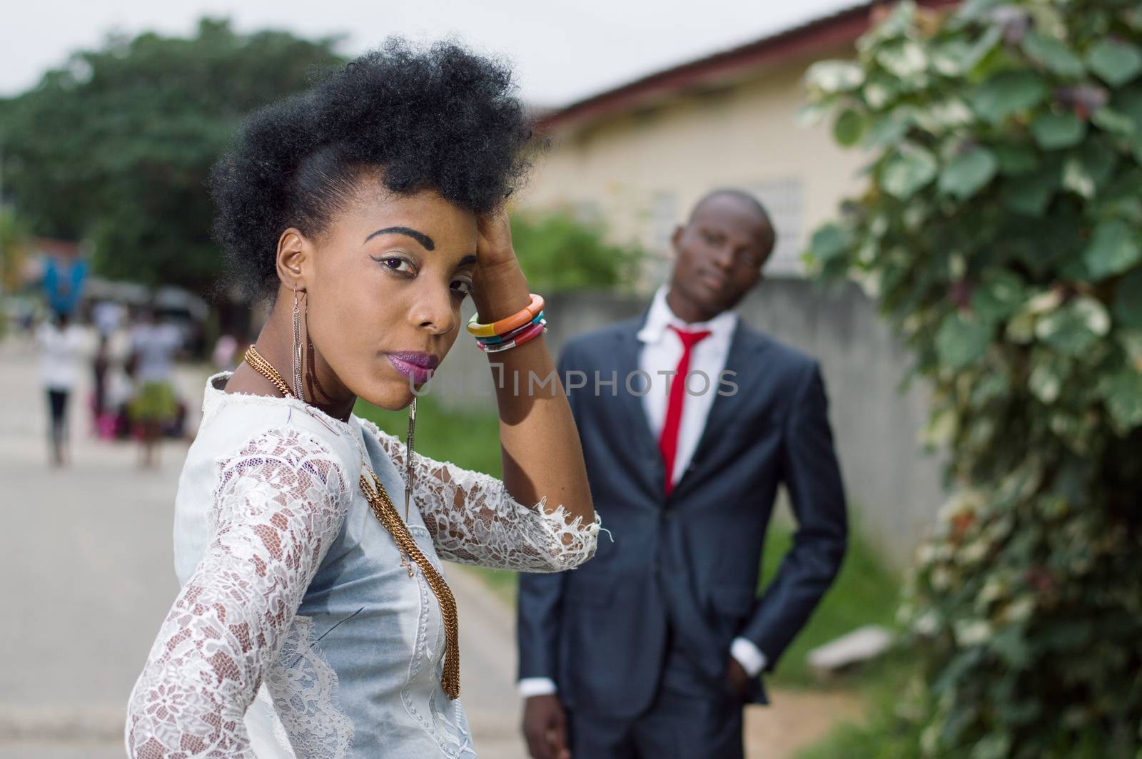 Young woman looking back and admired by her man in the street
